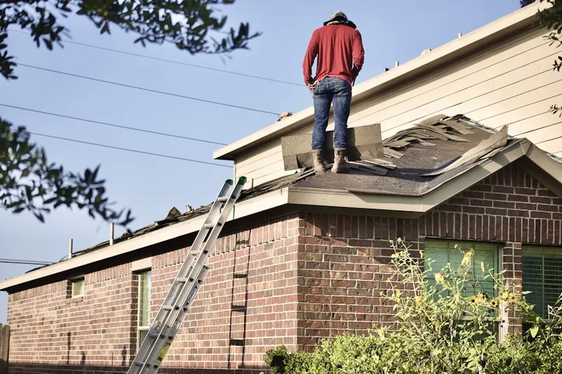 Professional roofer working on a residential roof in Skyland